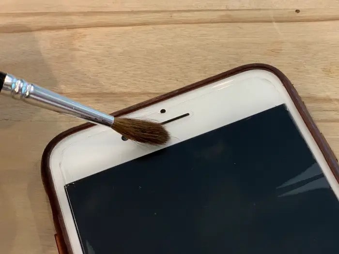 brush off dirt on iphone speaker